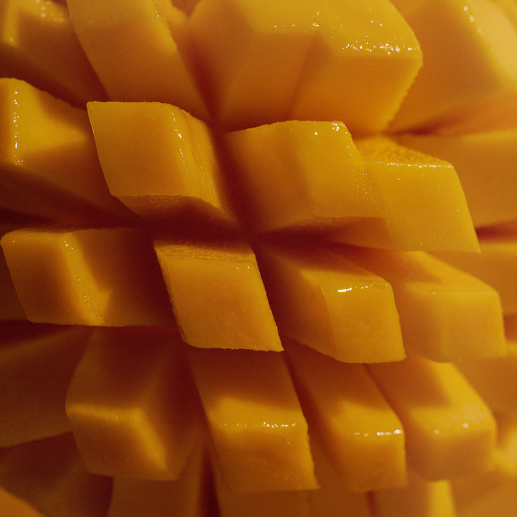 Close-up of fresh mango fruit cut into cubes in a hedgehog pattern